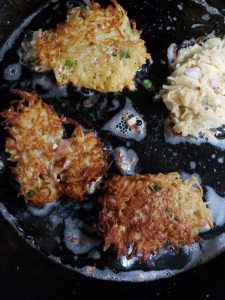 latkes cooking in the cast iron