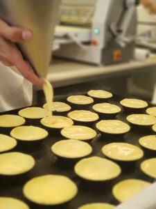 tarts being filled with custard