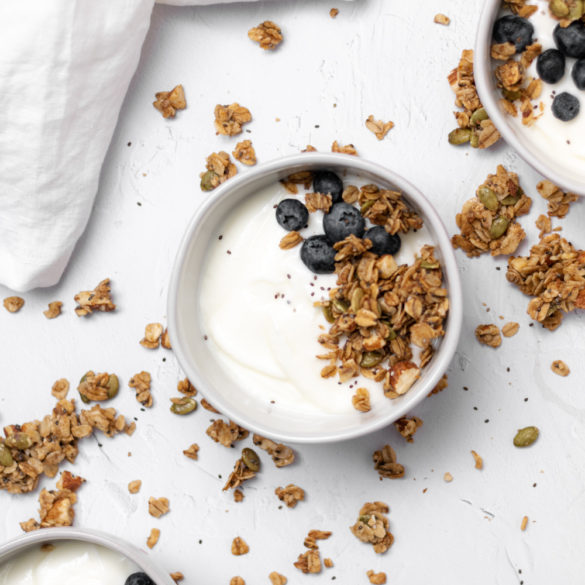 simple_granola_002 three bowls of yogurt topped with granola and blueberries