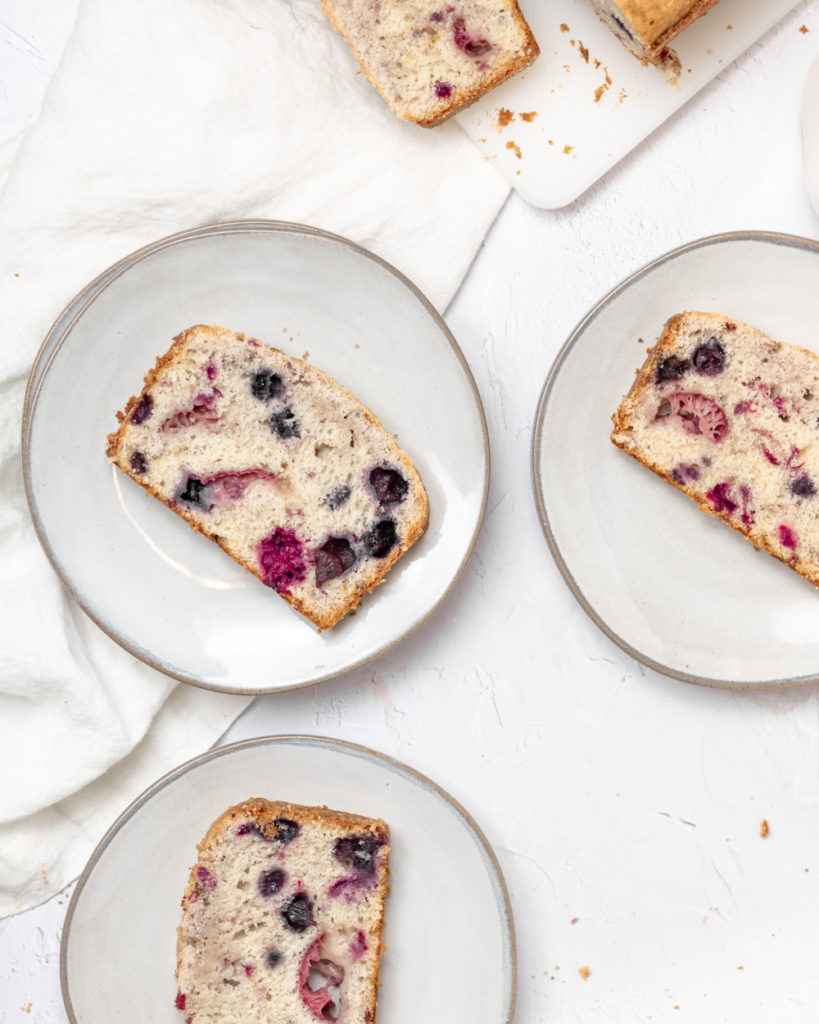 slices of triple berry loaf on plates